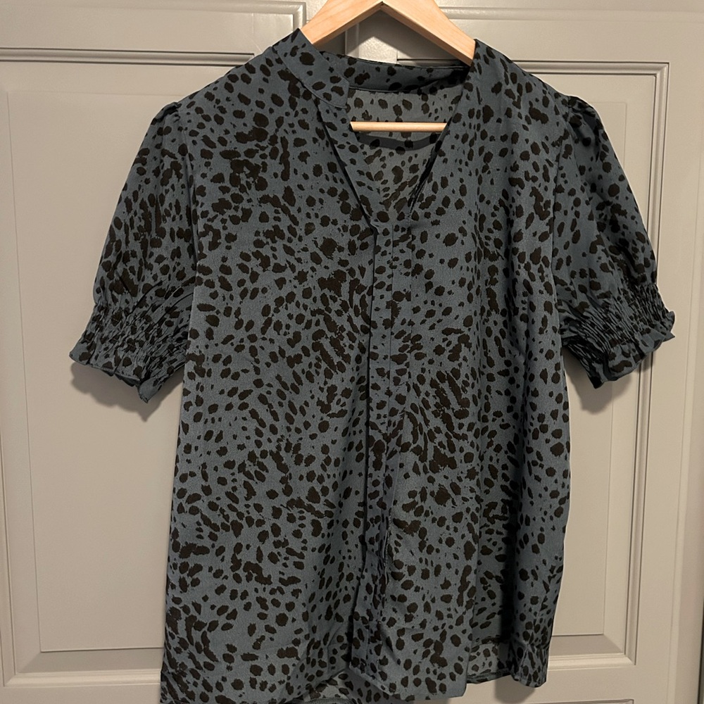 Sophisticated blue blouse with black leopard print.